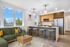 Apartments Portland, OR -Novus - Living Room with Spacious Windows, Wood-Style Flooring, and Outdoor Community View