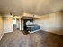 Kitchen with sink, stove, and fridge and carpeted living room