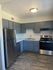 kitchen with vinyl wood like flooring and white appliances at Deer Valley Village