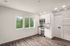kitchen and living area with wood-style flooring, built-in shelving, and large windows