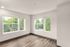 living area with large windows, wood-style plank flooring.
