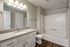 full bathroom with wood style plank flooring and shower/tub combo