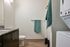 Bathroom in a studio apartment at Milano in Portland Oregon featuring a stackable in home washer and dryer