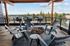Dog-Friendly Apartments in Bend, OR - The Hixon - Rooftop Deck & Resident Lounge with Breathtaking Panoramic Views, BBQ Grills, a Firepit, Chairs, and Tables