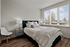 Bend, OR Apartments with In-Unit Washer and Dryer - The Hixon - Furnished Bedroom with Durable Plank Vinyl Tile Flooring, a Superior Vinyl Framed Oversized Window, and a Lot of Space