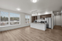 large open kitchen and living area with panoramic floor to ceiling windows and kitchen island