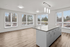 large open kitchen and living area with panoramic floor to ceiling windows and kitchen island