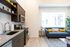 Open living area and kitchen with stainless steel appliances and modern fixtures