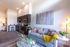 Open living area and kitchen with stainless steel appliances and modern fixtures