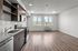 Studio kitchen with stainless-steel dishwasher, oven, range, microwave, and refrigerator, granite countertops and white subway-style backsplash featuring large windows