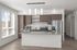 Large kitchen with stainless steel appliances, granite countertops, large windows and a kitchen island