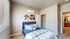 Bedroom with vinyl plank flooring and large windows