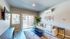 2-Bedroom Apartments In Reno, NV - Canyon's Edge - Living Room With Wood-Inspired Flooring And Glass Sliding Doors Leading To Private Balcony/Patio
