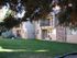 green grass and 2 story apartment building in the back at ala moana
