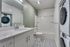 full bathroom with shower-tub combo and stacked washer and dryer at oner midtown