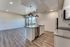 open kitchen with stainless steel appliances and floor to ceiling windows and patio door at oner midtown