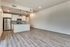 kitchen with stainless steel appliances and living room with wood like flooring at oner midtown