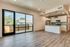 open kitchen with stainless steel appliances and floor to ceiling windows and patio door at oner midtown