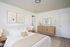 bedroom with brown carpet and a large closet