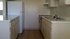 kitchen with wood like plank flooring and white appliances at palace apartments