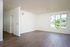 Living room with wood flooring and large windows
