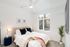 bedroom with ceiling fans and bed with decorative pillows and side tables
