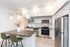 kitchen with stainless steel appliances and faux hardwood floors and quartz counters