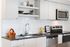 kitchen with quartz counters and tile backsplash and stainless steel appliances