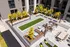 2-Bedroom Apartments In Milwaukie, OR - Henley Place - Outdoor Terrace With Bocce Ball Court, Strung Outside Lights, Couches, Hammock Garden, BBQ, Dining Table, And Fire Pit