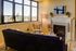 living room with blue suede sofa and arm chair next to gas fireplace