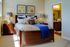 bedroom with carpet and bed with decorative accent pillows and side tables with lamps