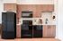 Stunning kitchen with all black appliances including a dishwasher, quartz countertops, and LVP flooring.