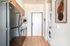 Kitchen and entrance area featuring a stackable in-home washer and dryer