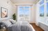 virtually staged bedroom with oversized windows adding to the natural light