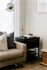 corner of a sofa with a black side table