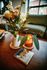 up close to a decorative plant on a coffee table and green sofa in the back