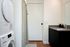 Bathroom with full sized washer and dryer