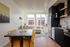 Apartments in Central Portland OR with In-Unit Washer and Dryer - Jute - Interior with an Open-Concept Kitchen and Dining Area, Large Windows, and a Cozy Living Space with Natural Light.