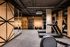 Dog-Friendly High Rise Apartments in Portland OR - Jute - Gym with Mood Lighitng, Wood Walls, Exposed Pipe Ceiling, Mirrors, Machines, and Weights