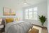 bedroom with wood floor, ceiling fan and window