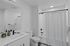 Bathroom with tub/shower combo and quartz countertops