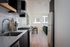 Portland OR Studios for Rent - Jute - Modern Ktichen with Stainless Steel Appliances, White Tile Backsplash, and Matte Black Cabinetryvirtual staged living room and kitchen