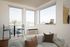 Pet-Friendly High Rise Apartments in Portland OR - Jute - Living Room with Expansive Windows, White Walls, a High-Top Dining Table with Stools, Wood-Style Flooring, and a Light Couchvirtual staged living room