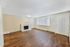 living room with fireplace and faux wood flooring at quad apartments