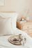 white bed with breakfast croissant and coffee on the bed