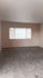 Carpeted bedroom with large windows