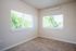 bedroom with large windows and carpeted flooring