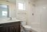 bathroom with toilet, sink, and shower