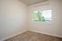 bedroom with large window and carpeted flooring