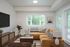 Albany, OR, Apartments for Rent - Creekside Meadows - Living Area with White Walls, Wood-Look Flooring, a Sectional Sofa and Lamp, Coffee Table, TV Console, and Seating Area Set Off with an Area Rug.